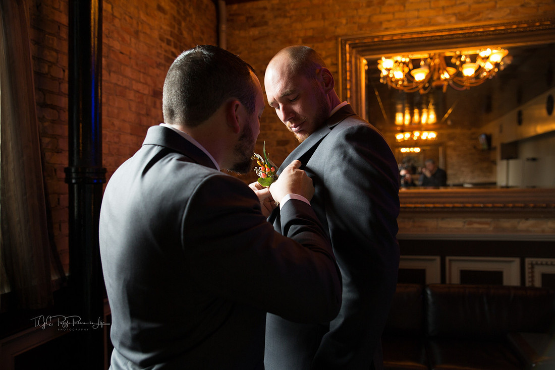 Bestman puts Groom's boutonniere on/ The Allure/ Laporte, In/ Northwest Indiana Wedding Photographer